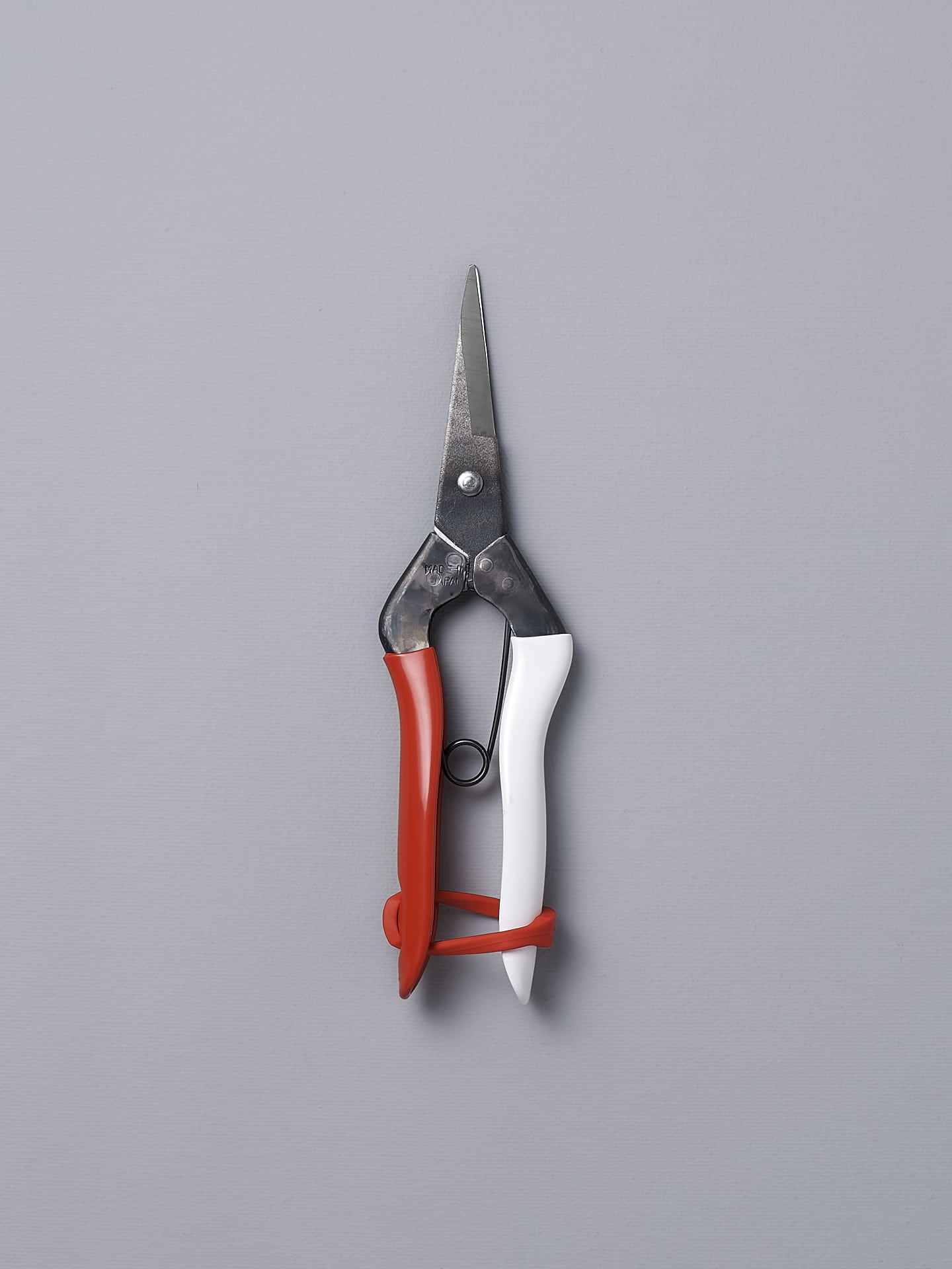 A pair of Okatsune Japanese Snips №304 on a gray background.