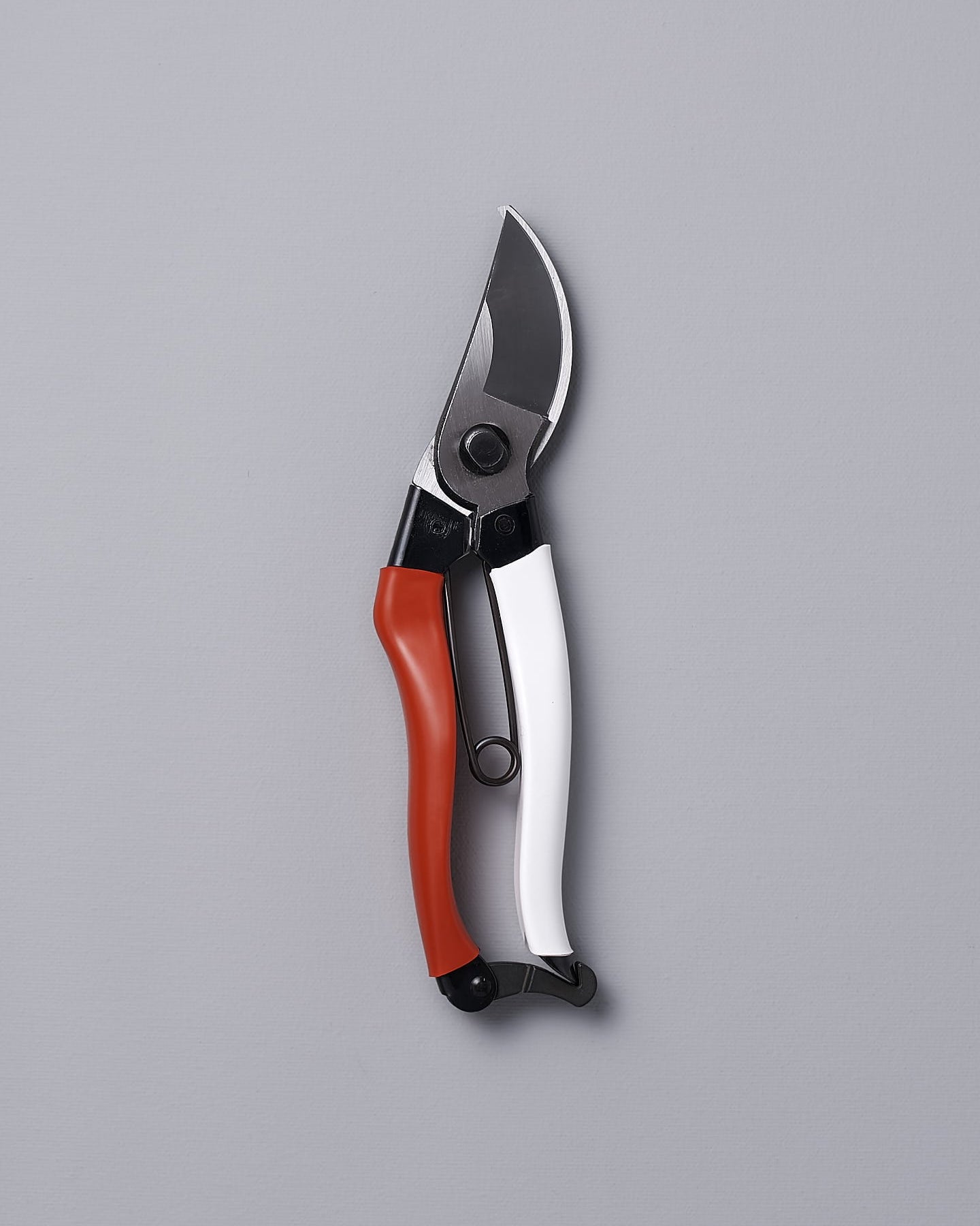 An Okatsune Japanese Secateurs №103 on a gray background.
