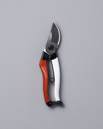 An Okatsune Japanese Secateurs №103 on a gray background.