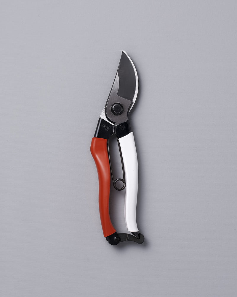 An Okatsune Japanese Secateurs №103 on a gray background.