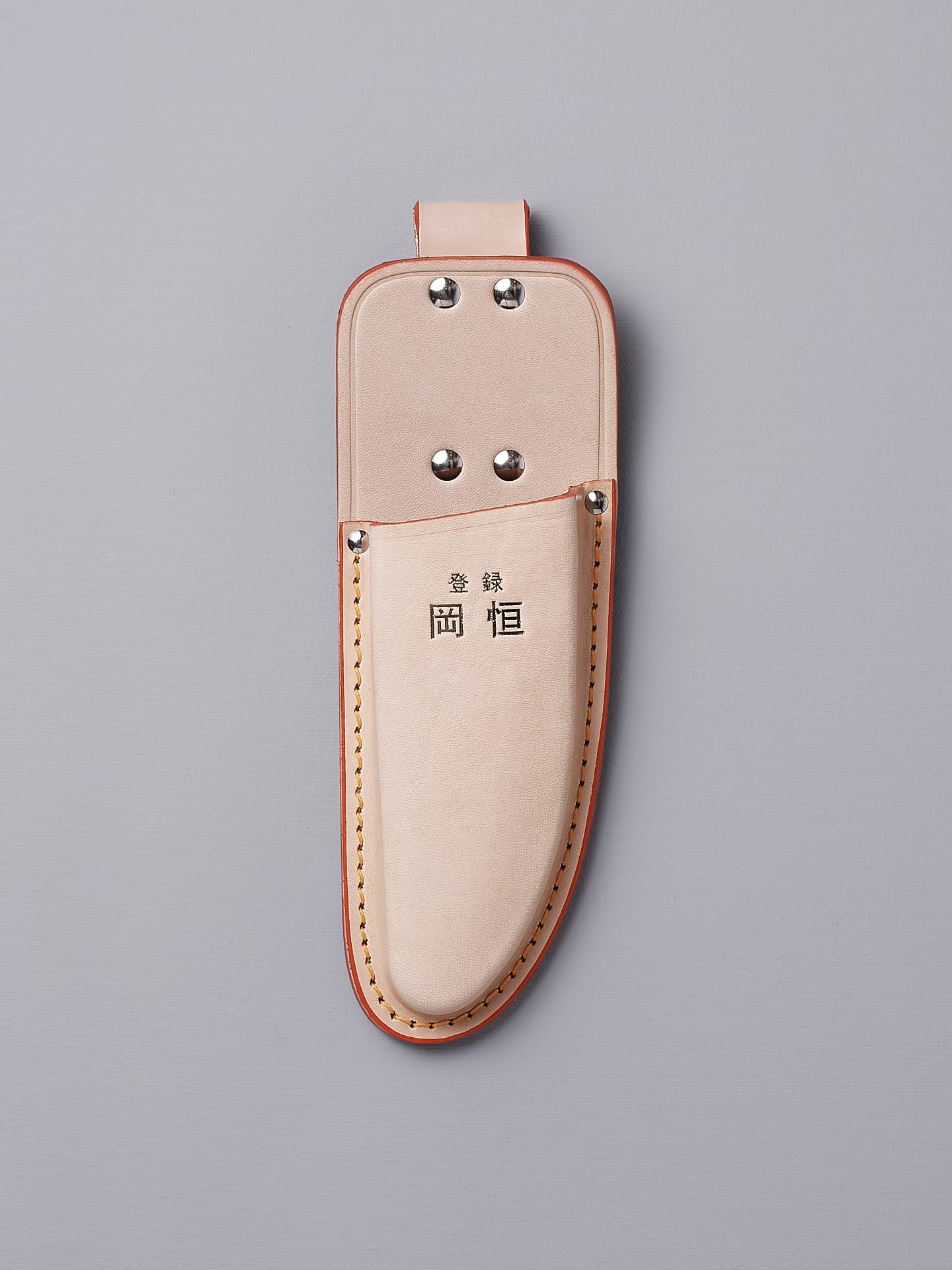 An Okatsune Single Leather Holster with a leather handle.