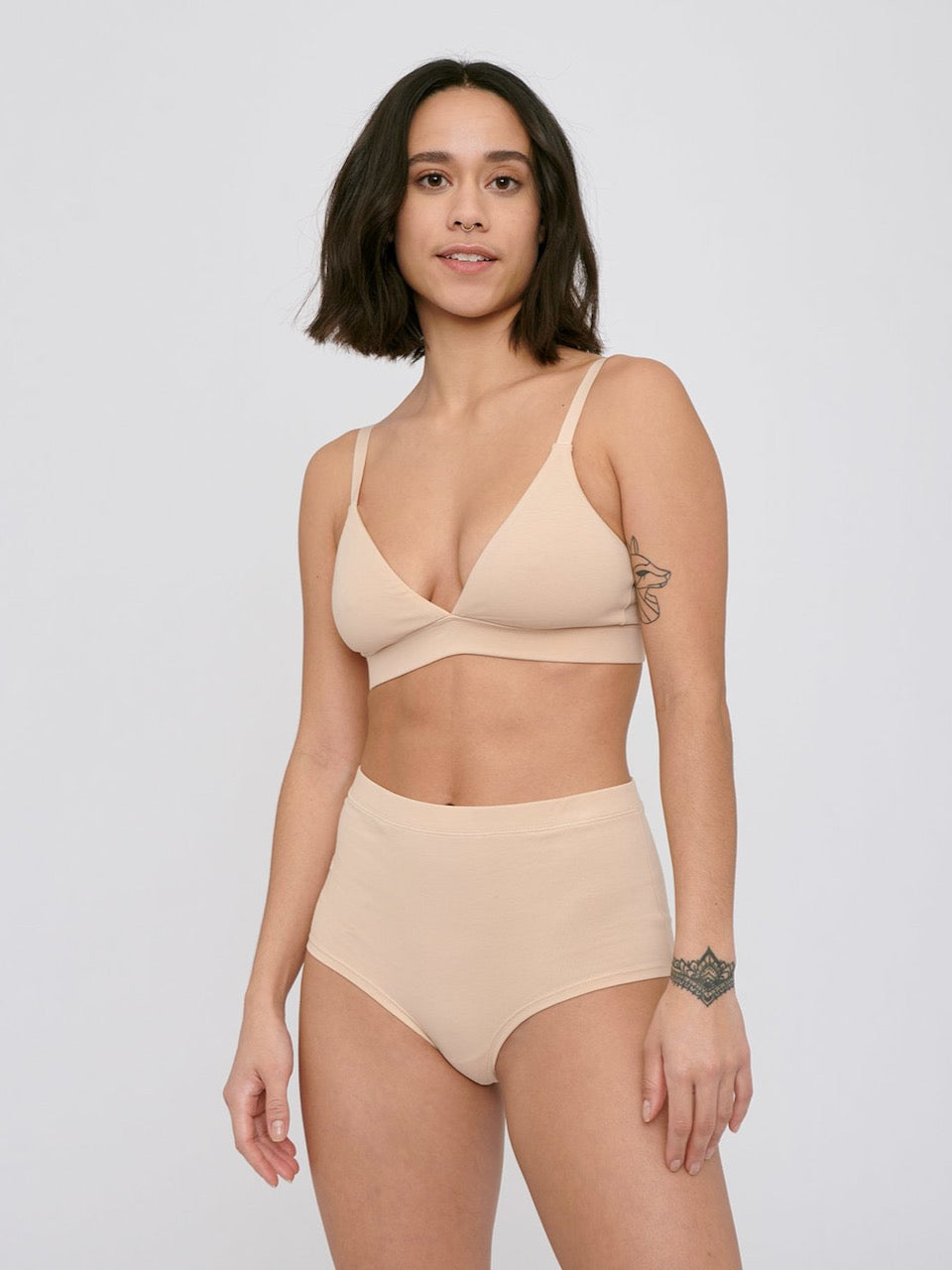 A woman in a Super High-Rise Briefs ⋅ organic cotton (2-pack) – Oak bikini top and panties by Organic Basics.