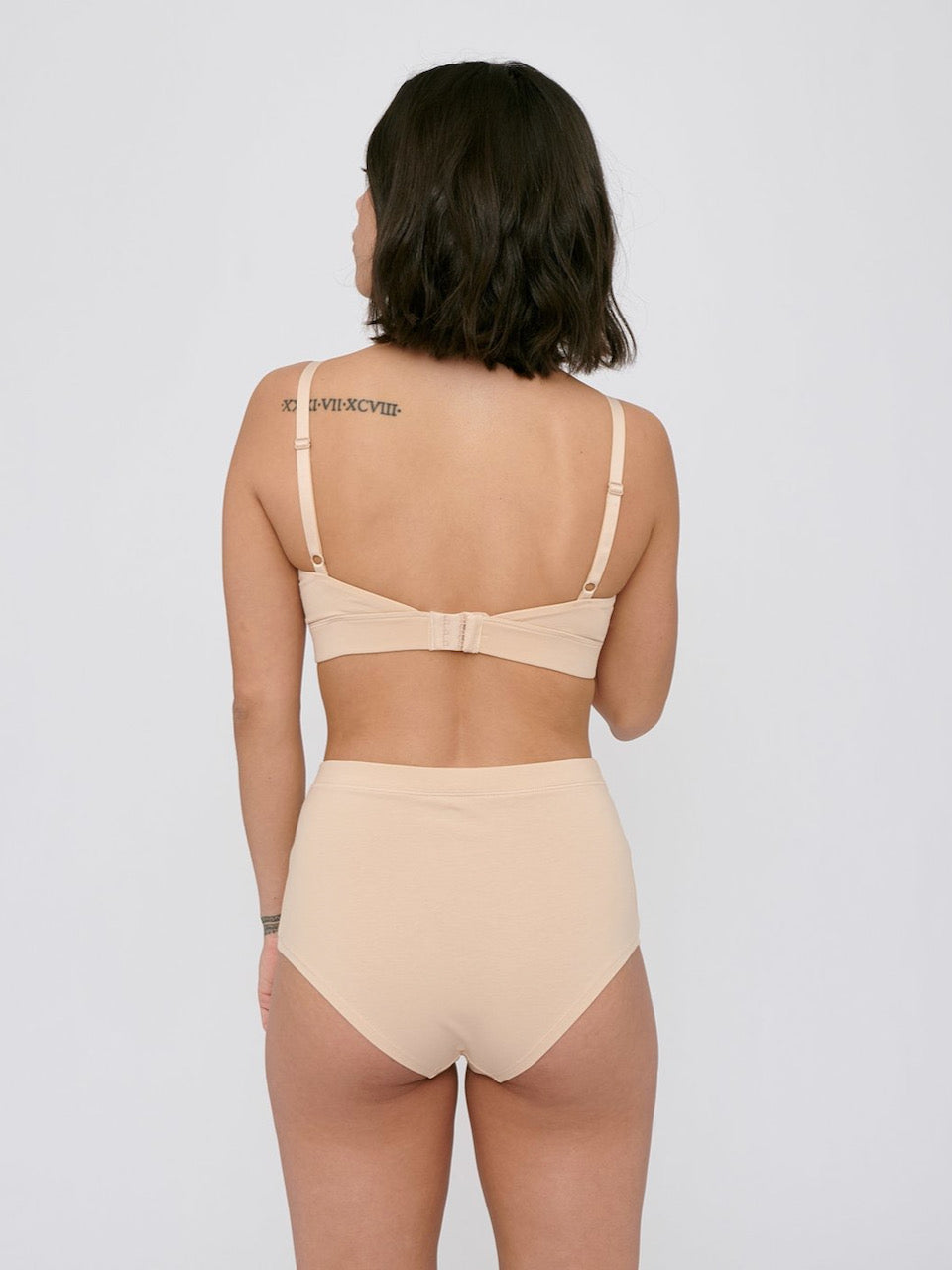 The back view of a woman wearing Super High-Rise Briefs ⋅ organic cotton (2-pack) – Oak by Organic Basics.