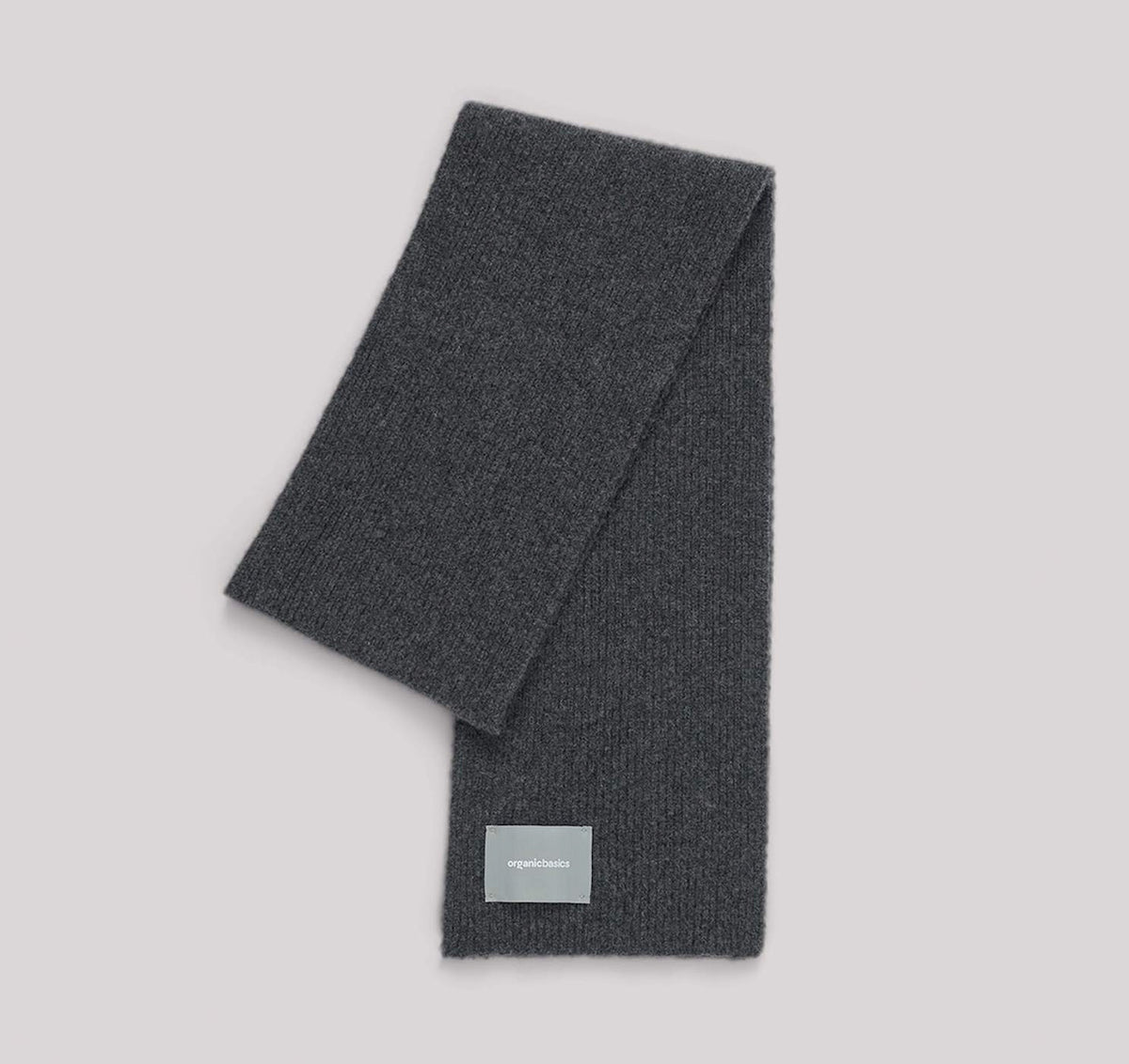 An Organic Basics Recycled Wool Scarf – Charcoal Melange with a label on it.