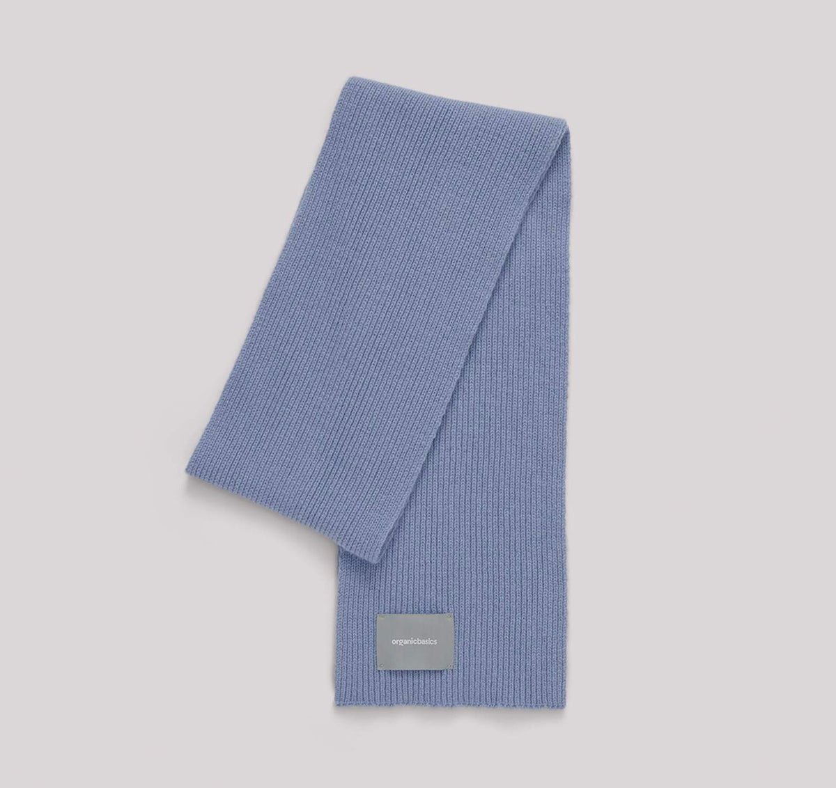 An Organic Basics Recycled Wool Scarf – Light Blue on a white background.
