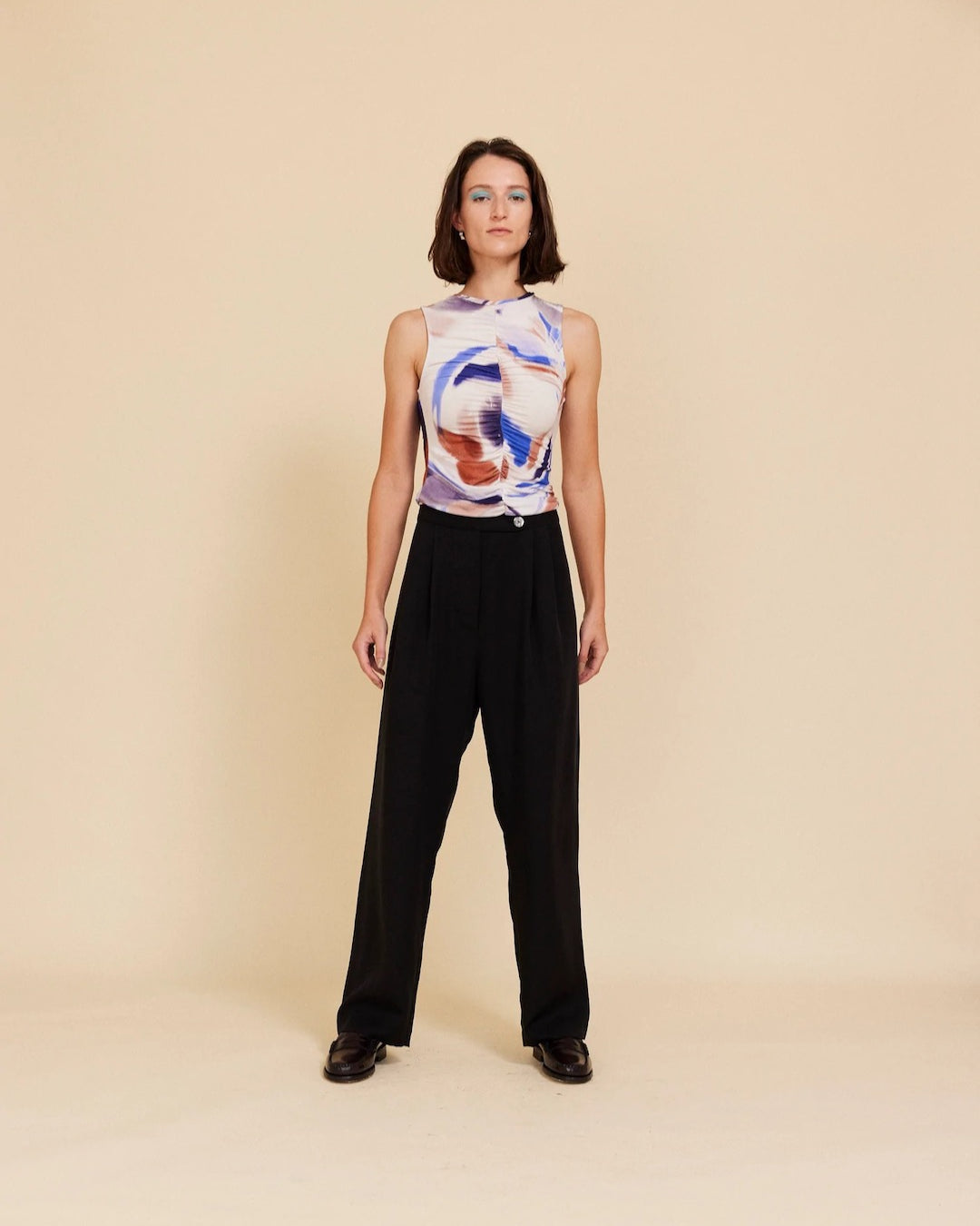 A woman wearing OVNA OVICH's Me Time Trouser – Onyx and a black top.
