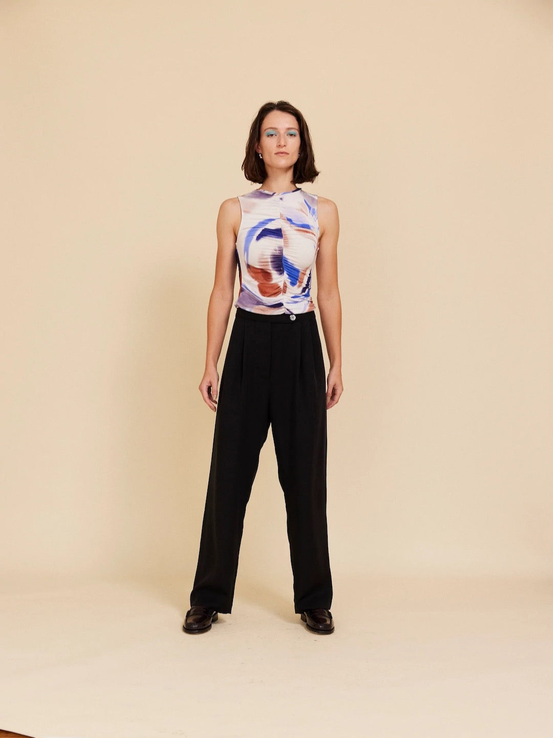 A woman wearing OVNA OVICH&#39;s Me Time Trouser – Onyx and a black top.