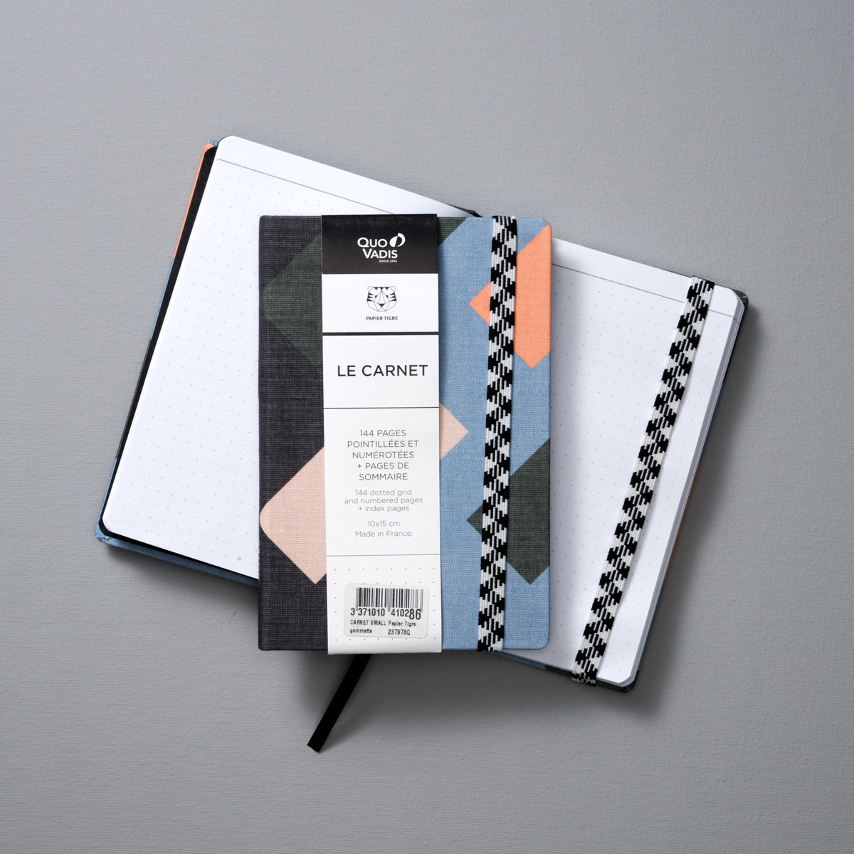 An A6 Canvas Notebook - Dot Grid from Papier Tigre with a checkered pattern on it.