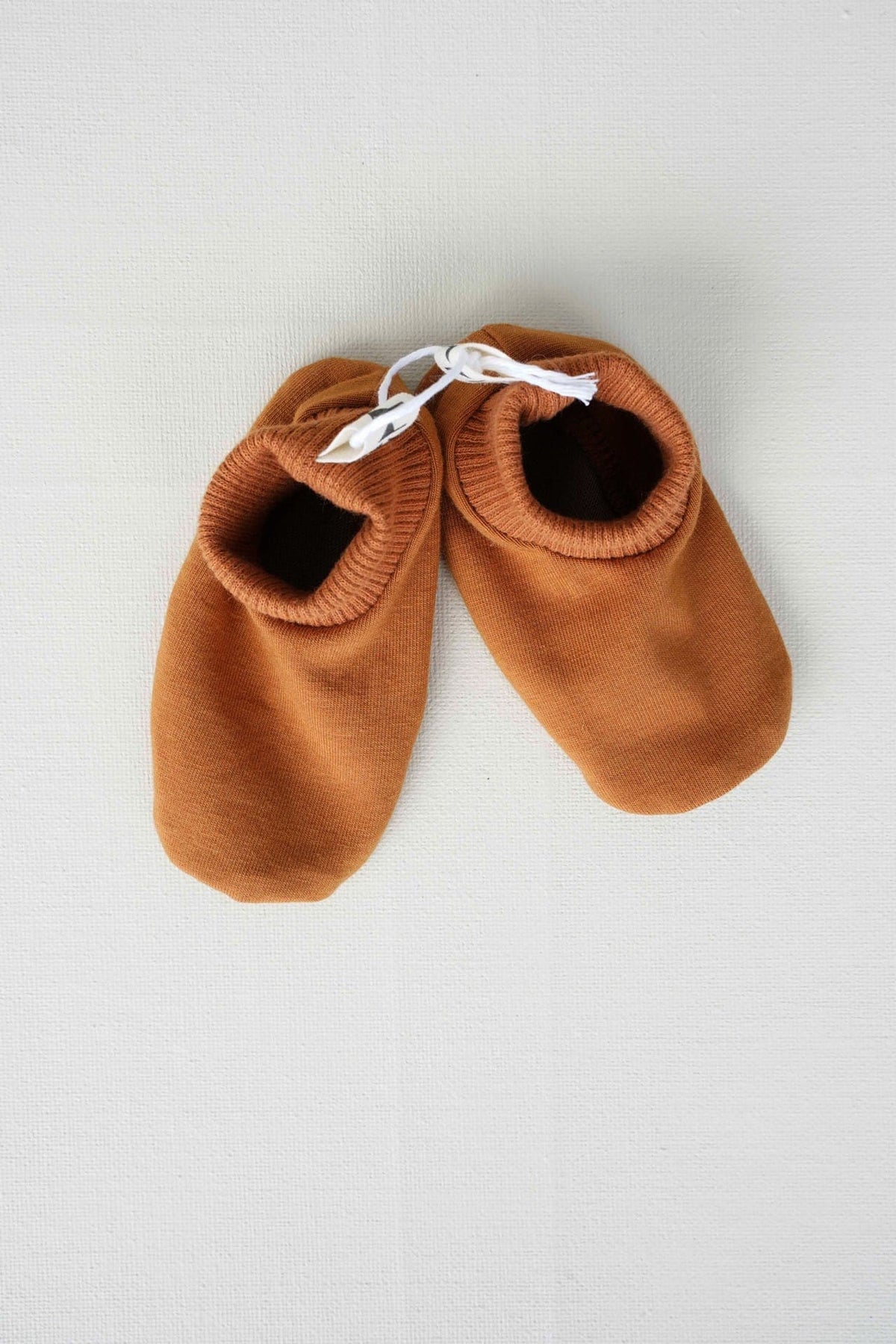 A pair of brown Baby Gift Box – Copper baby shoes by Peppin on a white surface.
