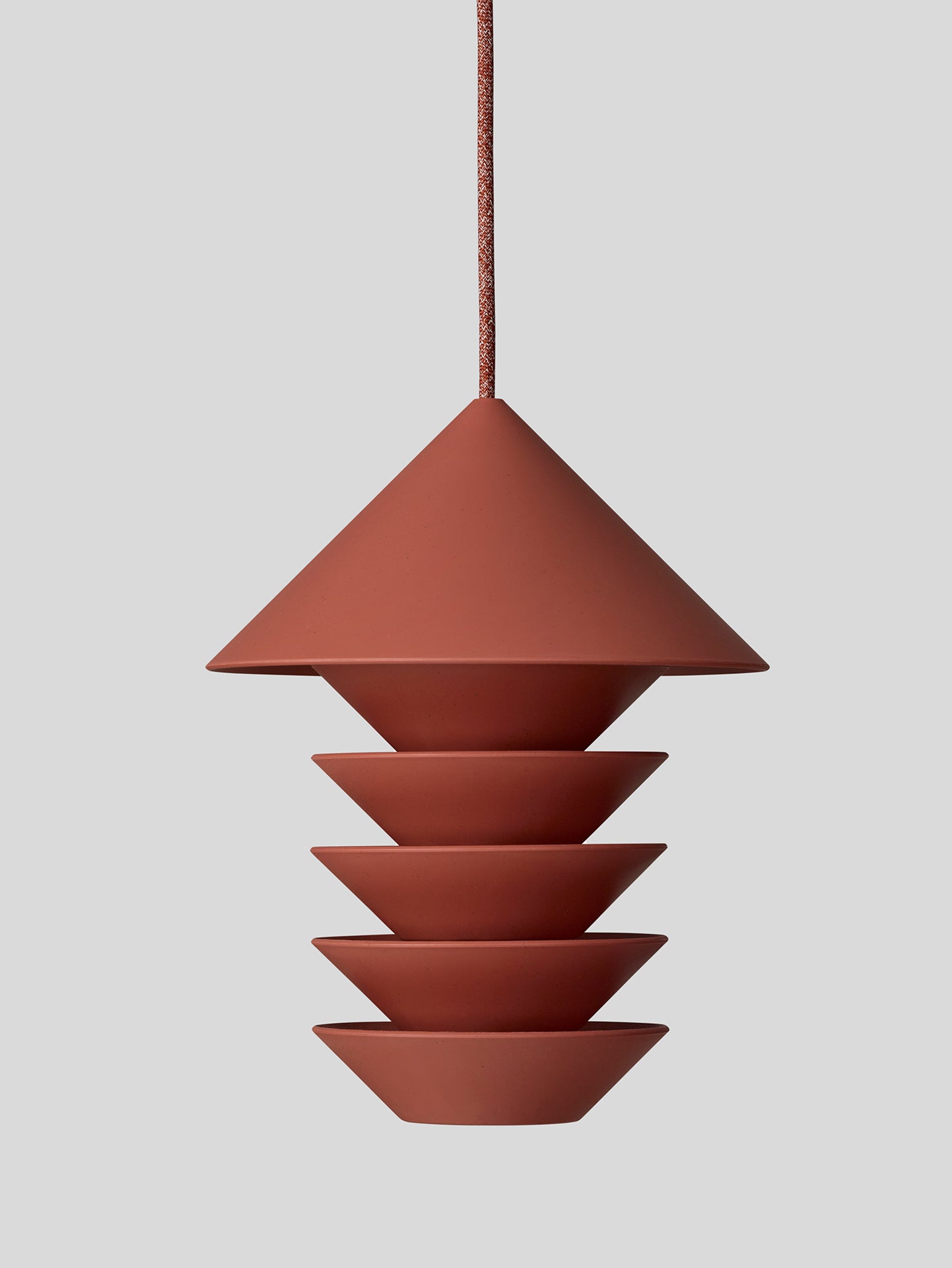 A Bird Silo – Terracotta pendant light hanging on a gray background. (Product: Bird Silo – Terracotta; Brand: Pidät)