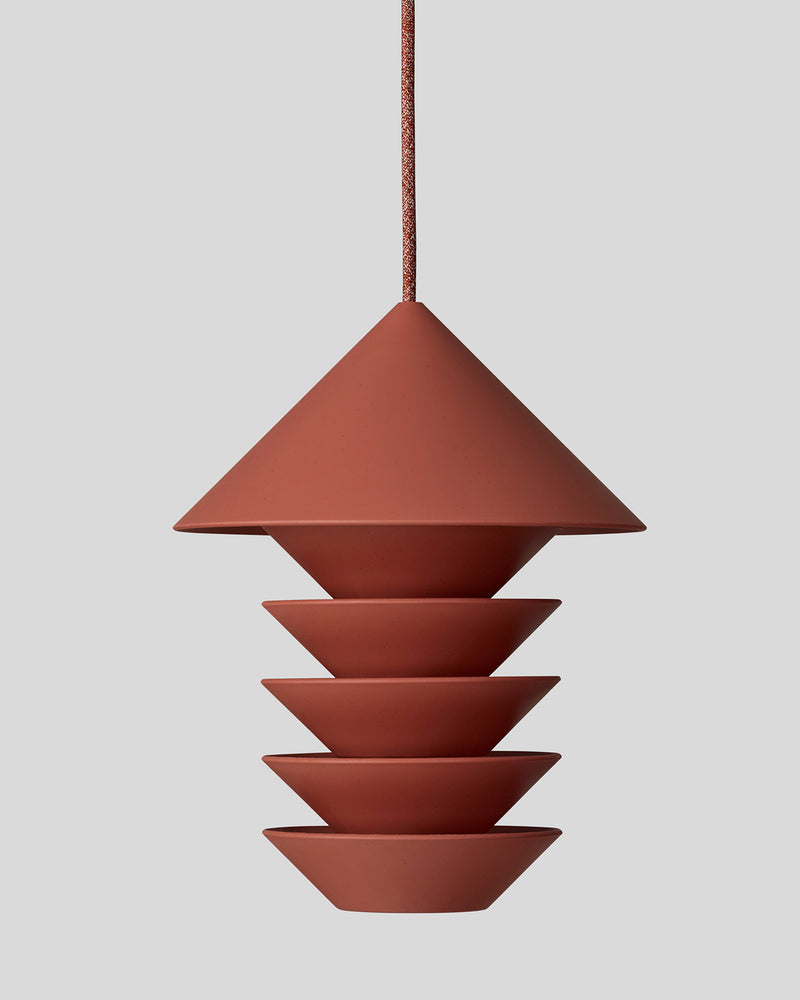 A Bird Silo – Terracotta pendant light hanging on a gray background. (Product: Bird Silo – Terracotta; Brand: Pidät)