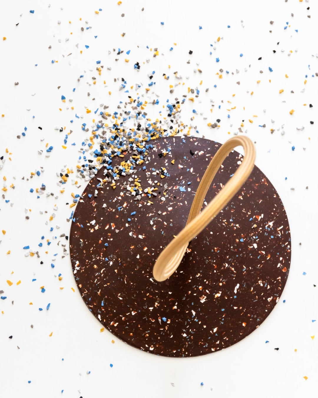 A STOP – Doorstop with confetti and a wooden spoon.