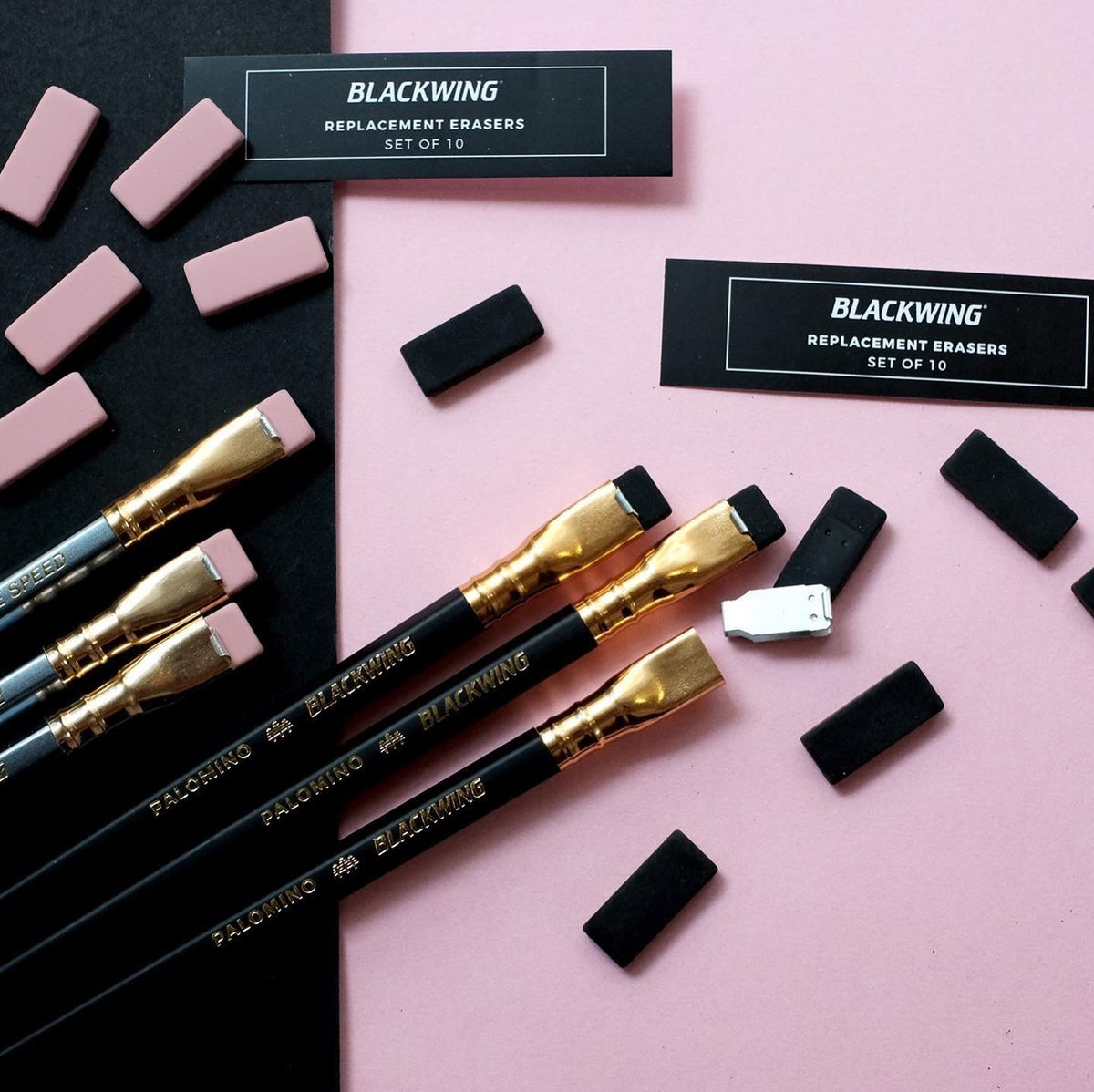 A collection of Palomino Blackwing pencils with Replacement Eraser 10pk - White ⋄ Black ⋄ Pink design erasers on a pink surface.