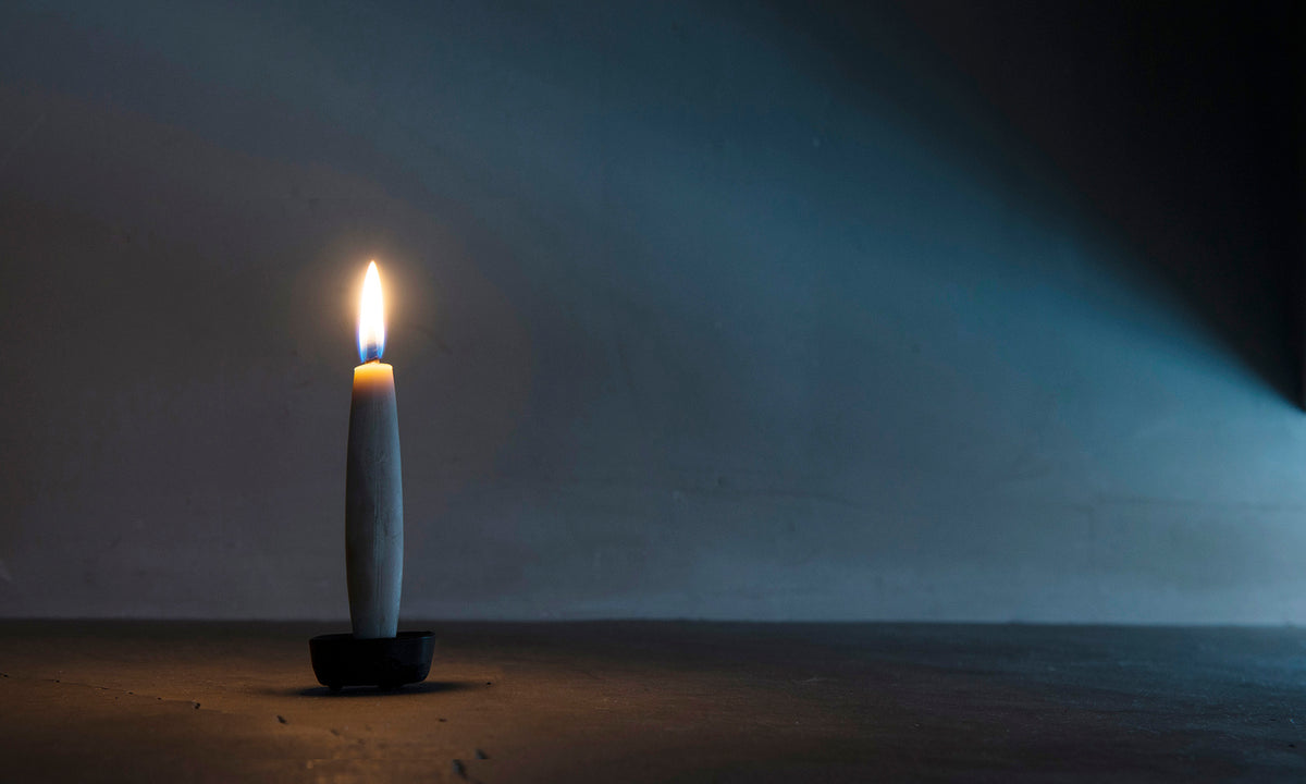A TOHAKU candle in a dark room. (Takazawa)