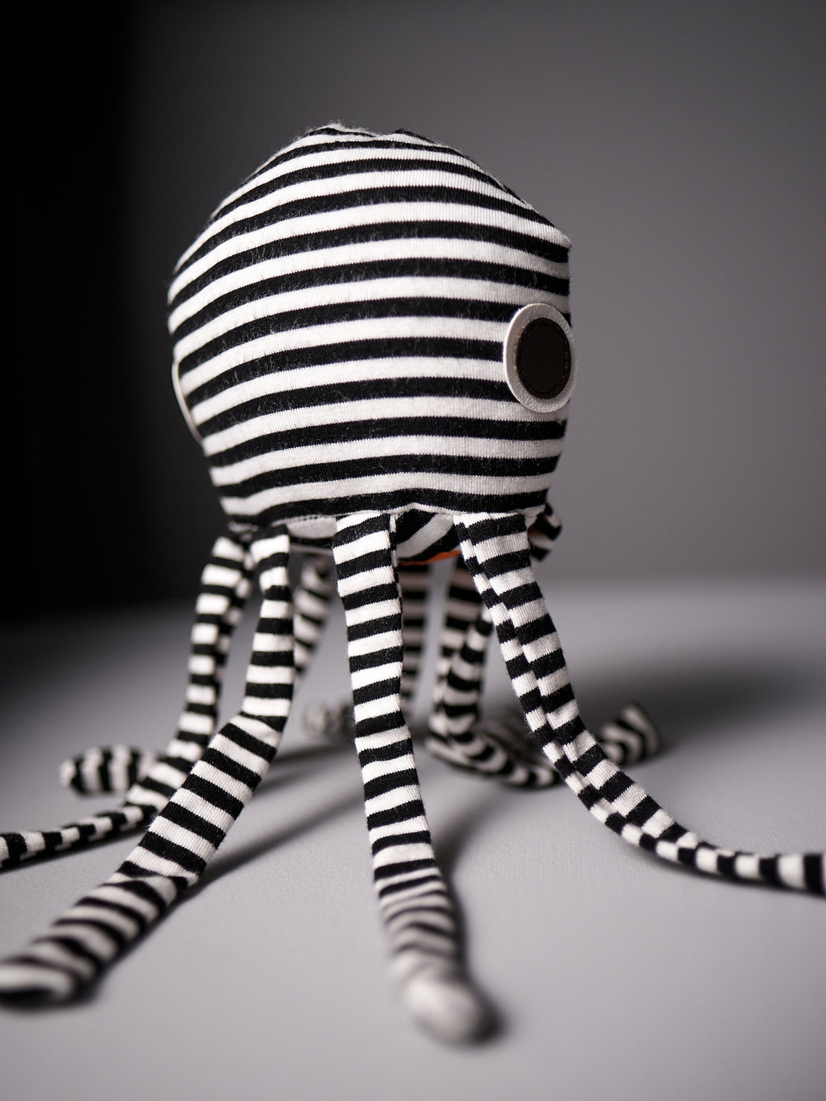 A black and white striped Émile la Pieuvre stuffed animal by Raplapla.