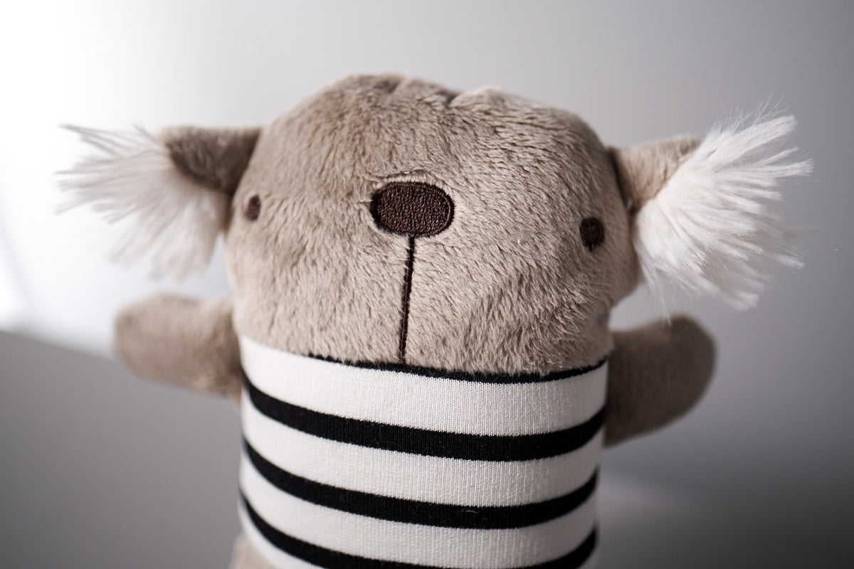 A Gilles le Koala stuffed bear wearing a striped shirt from Raplapla brand.