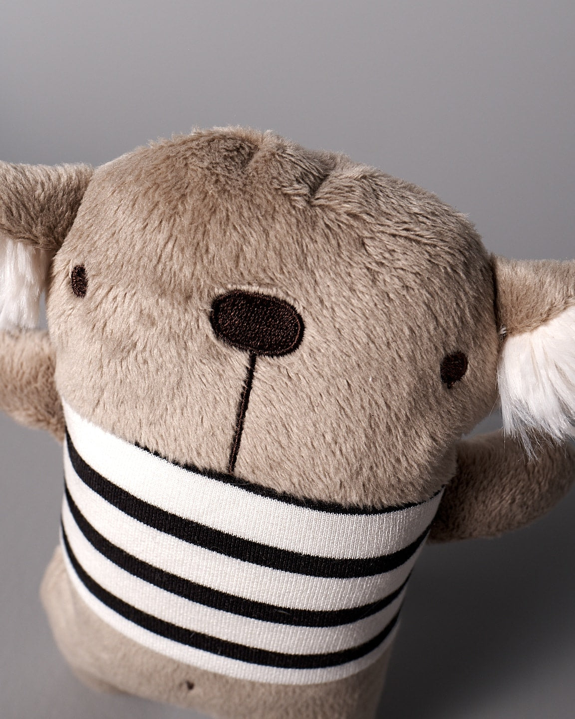A Raplapla stuffed koala named Gilles le Koala with a black and white stripe.