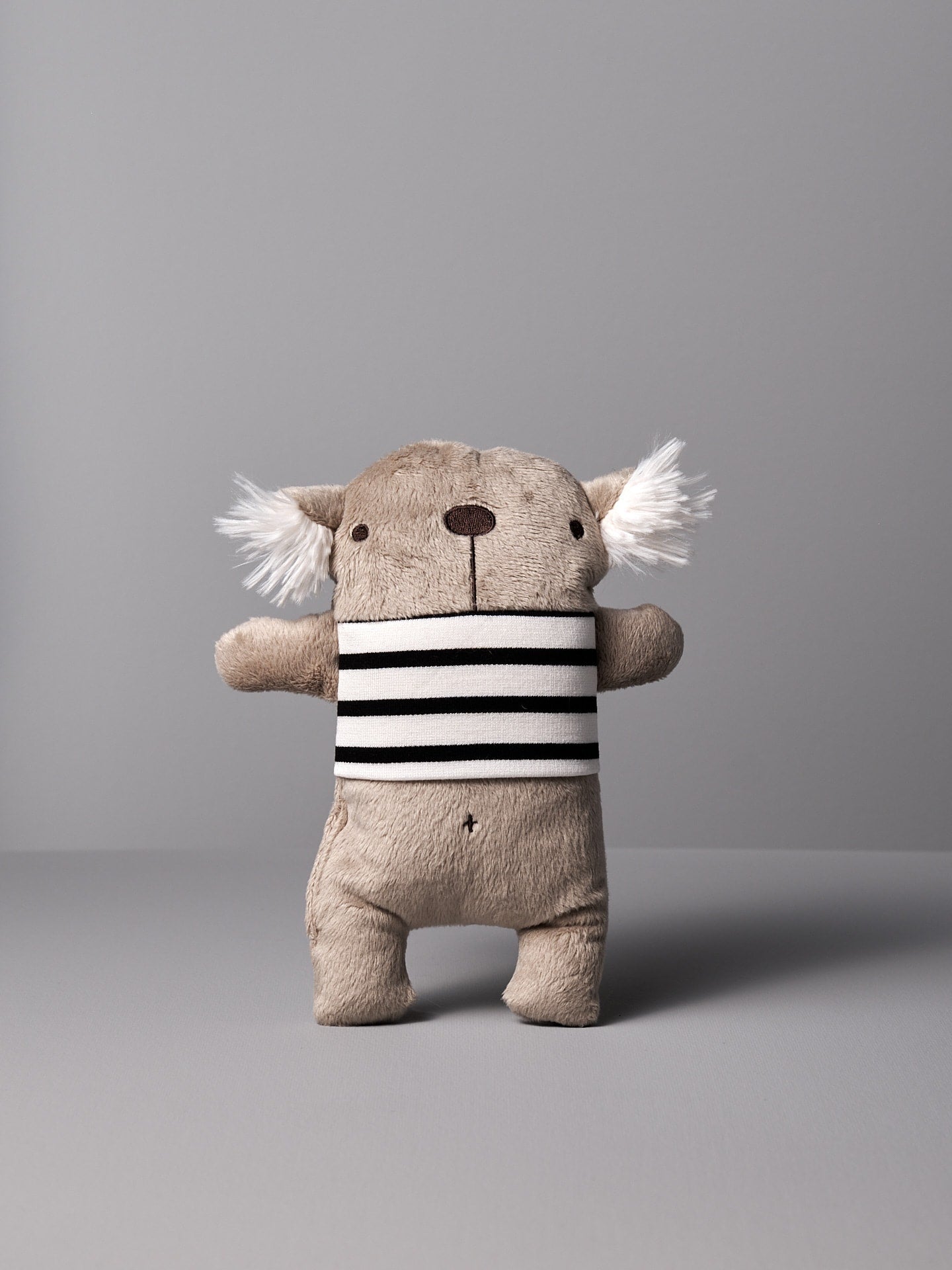 A Raplapla stuffed koala named Gilles le Koala with a black and white stripe.