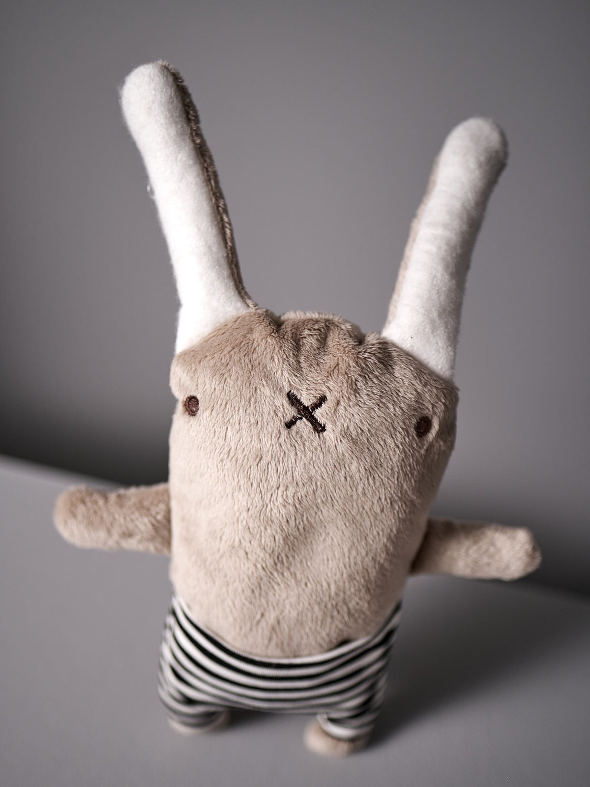 A Louise la Lapine stuffed bunny wearing striped pants from Raplapla.