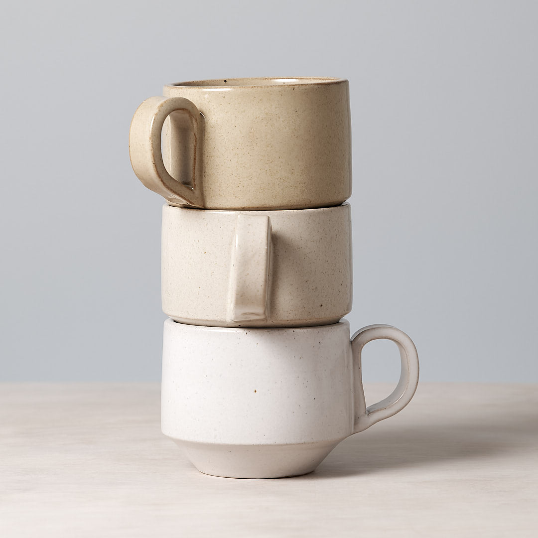 Three Richard Beauchamp Medium Stacking Mugs – White stacked on top of each other.