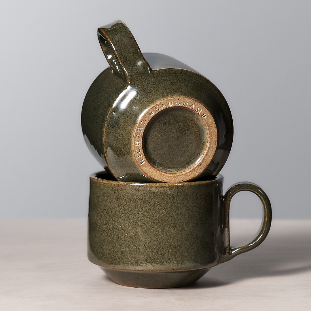 Two Richard Beauchamp Medium Stacking Mugs – Green sitting on top of each other.