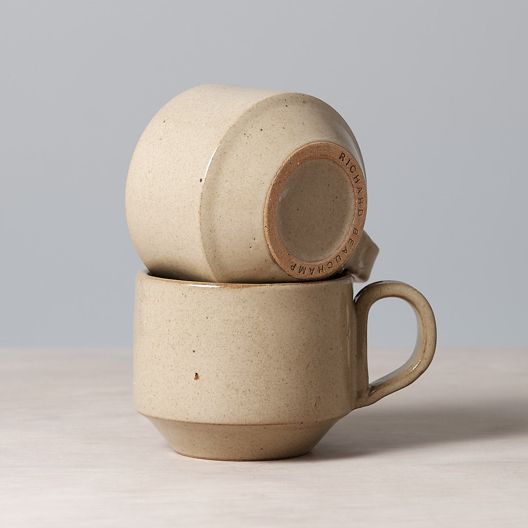 Two Richard Beauchamp Medium Stacking Mugs- Sand sitting on top of each other.