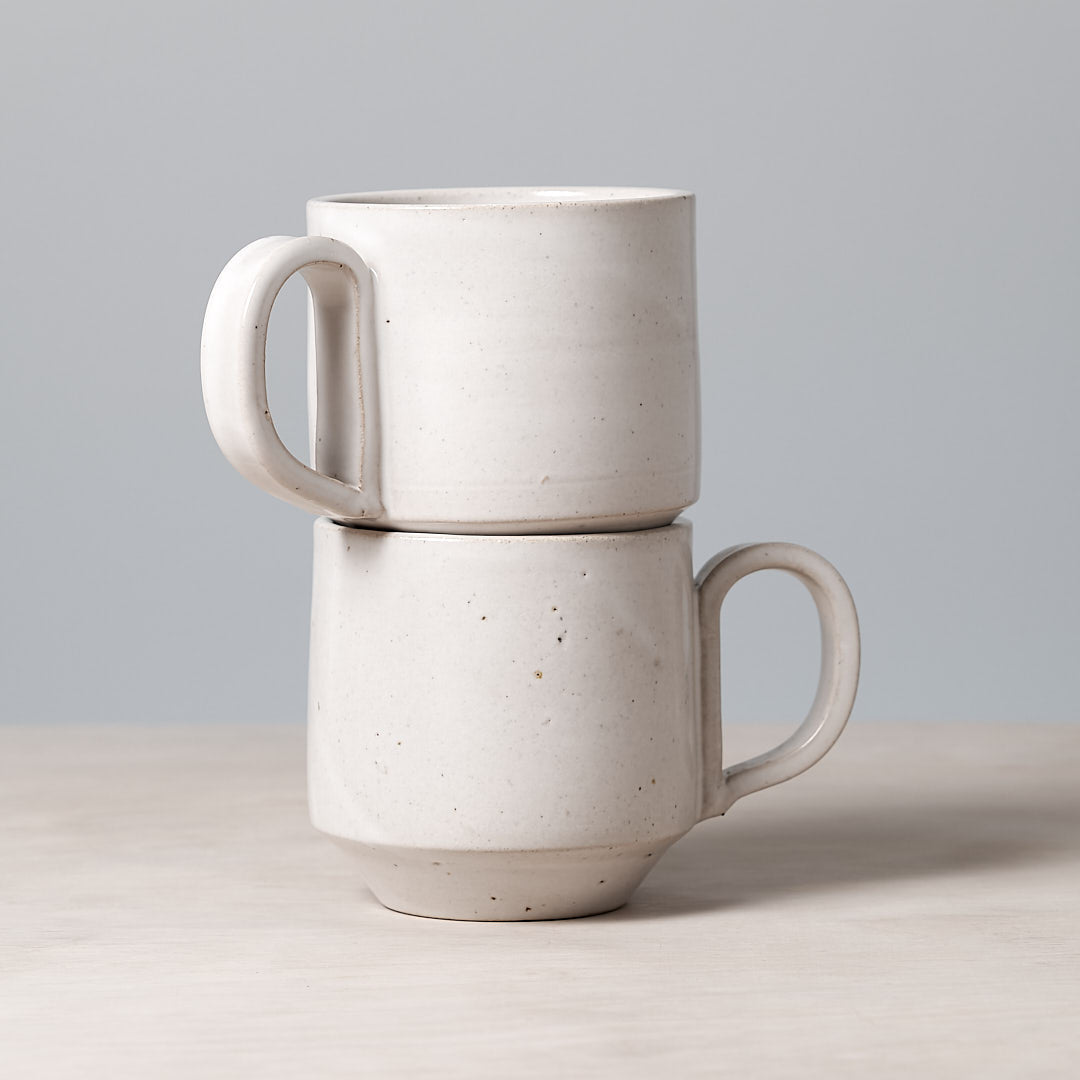 Two Richard Beauchamp Large Stacking Mugs – White stacked on top of each other.