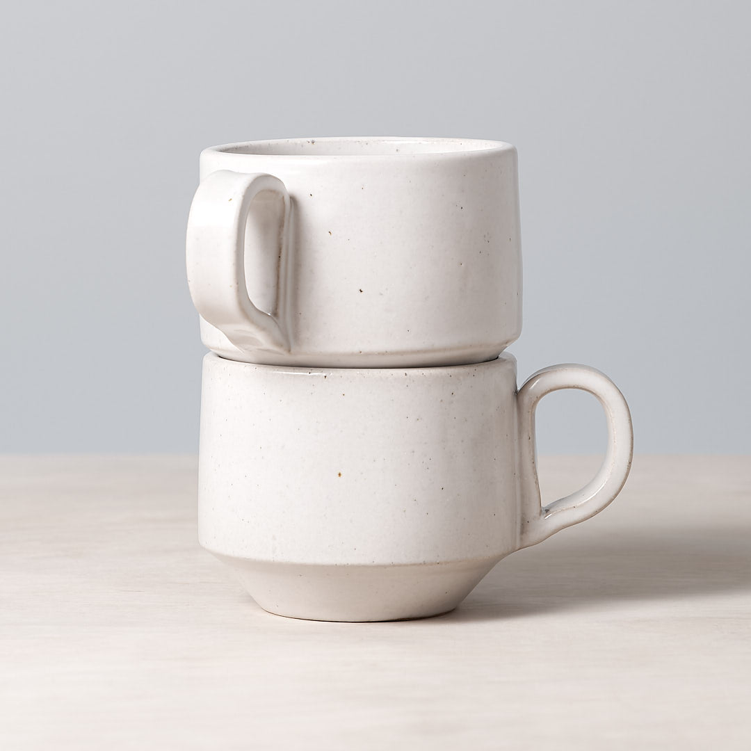 Two Richard Beauchamp Medium Stacking Mugs – White stacked on top of each other.