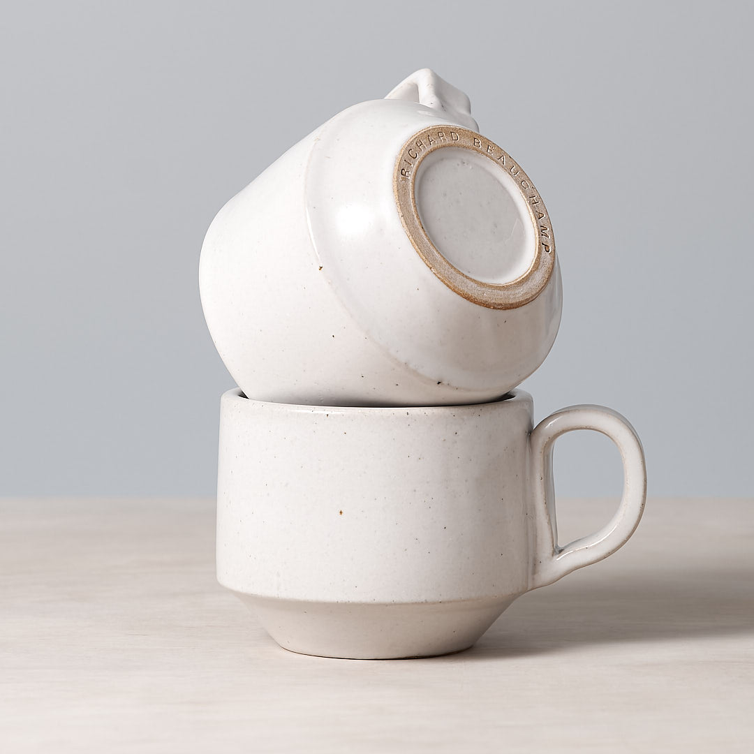 Two Richard Beauchamp Medium Stacking Mugs - White stacked on top of each other.