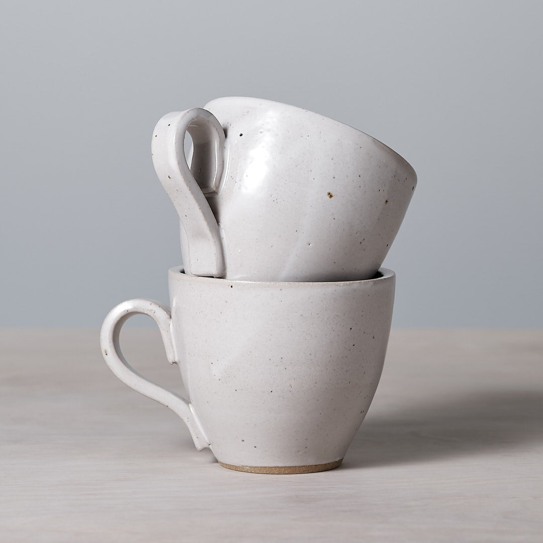 Two Richard Beauchamp Tulip Cup - White mugs stacked on top of each other, with a satin glaze.