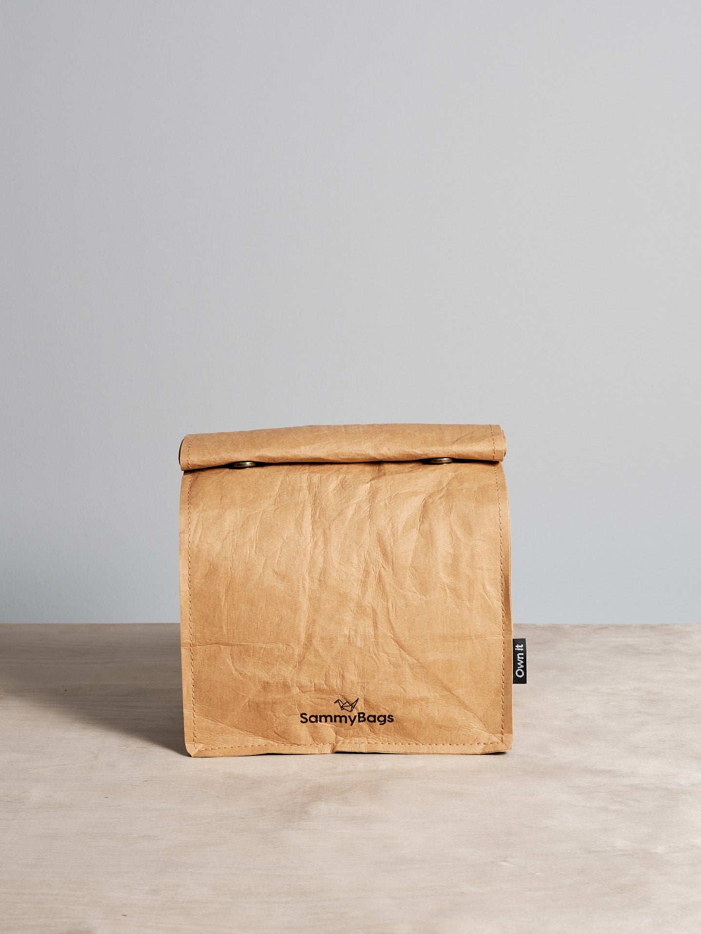 A Reusable Lunch Bag from Sammy Bags sitting on a wooden table.