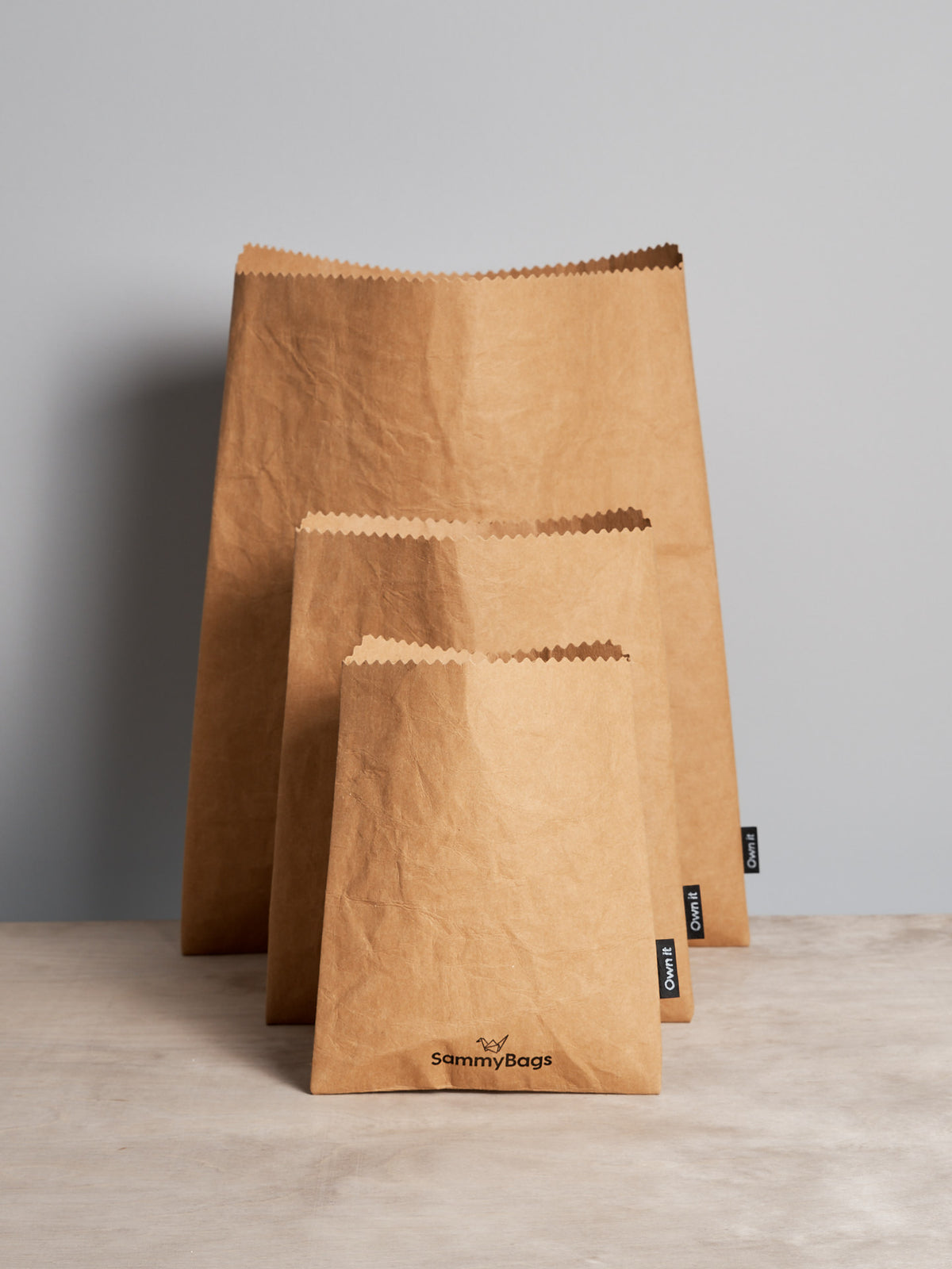 Three Sammy Bags Reusable Flat Bag – Small on a table.