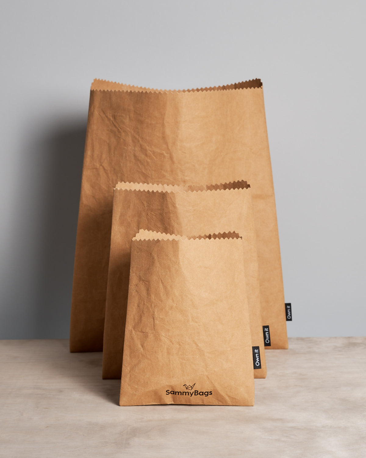 Three Sammy Bags Reusable Flat Bag – Medium on a table.