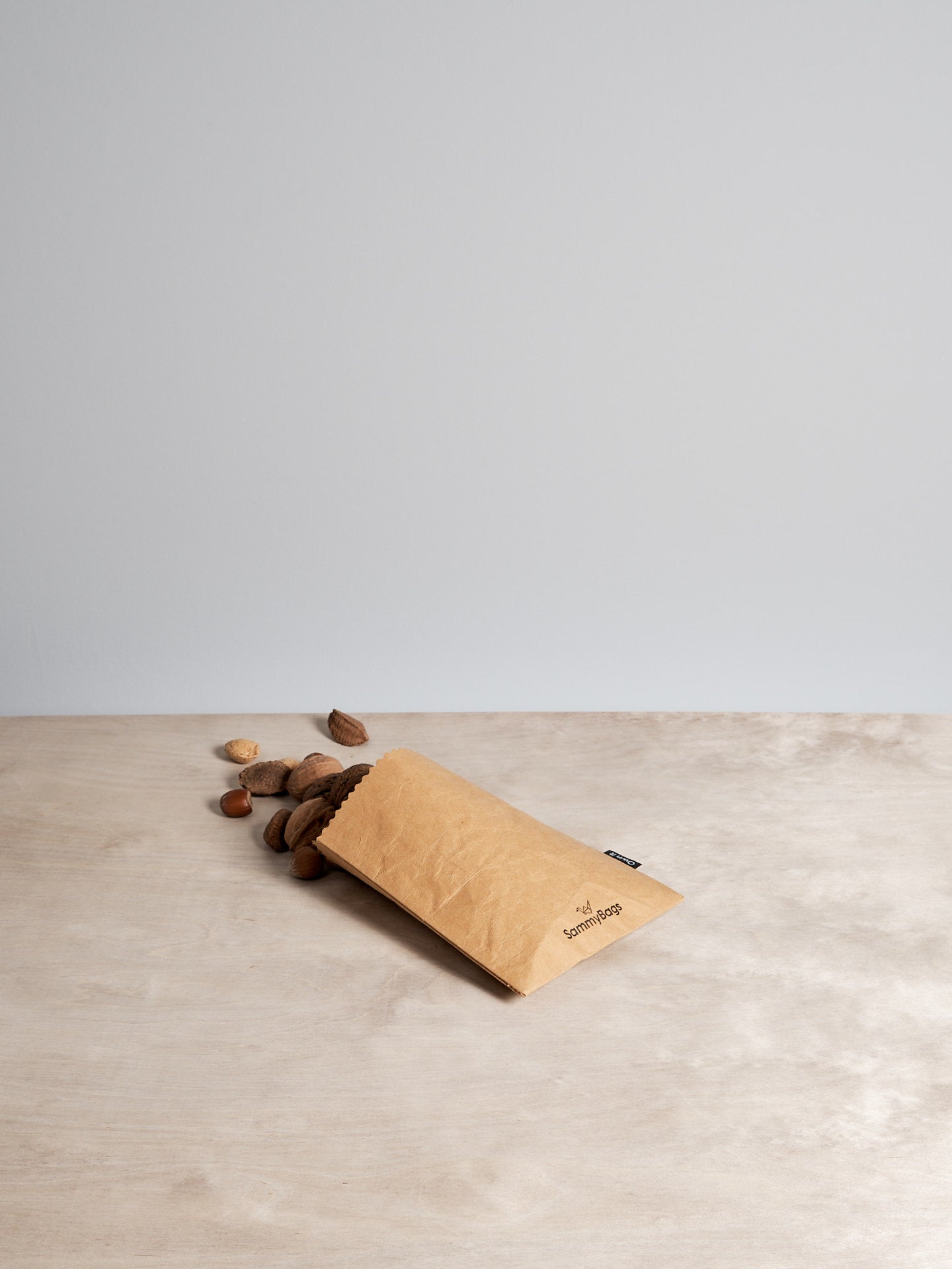 A Sammy Bags Reusable Flat Bag – Small sitting on top of a wooden table.