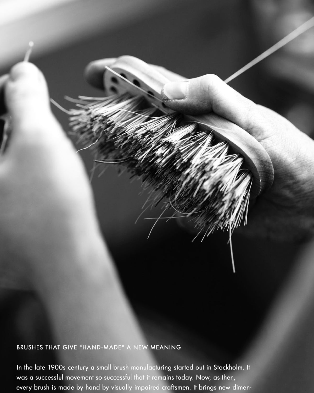 A black and white photo of a person brushing a shoe with an Iris Hantverk vegetable brush.
