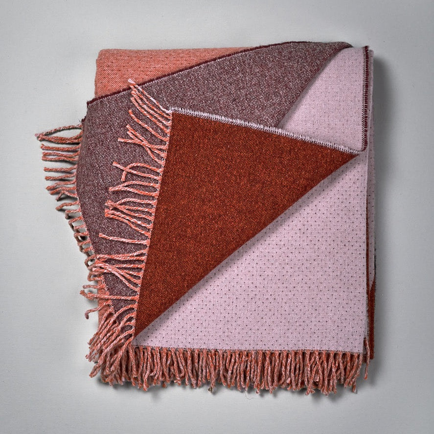 A pink and brown Dune Blanket with fringes by Seljak Brand.