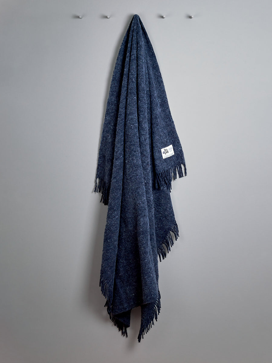 A Indigo Blanket – Fringe hanging on a wall, from Seljak Brand.