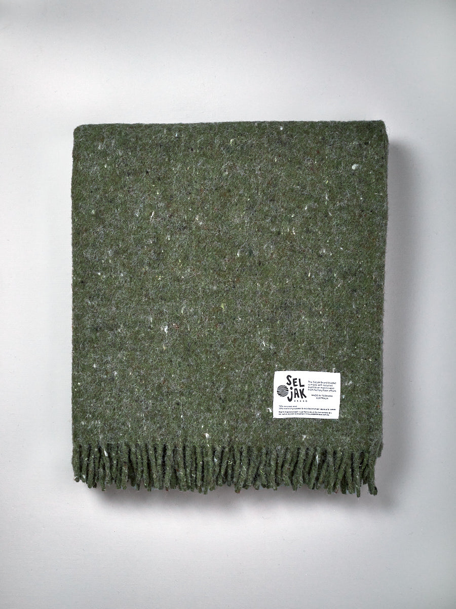 A Moss Blanket – Fringe with a label on it.