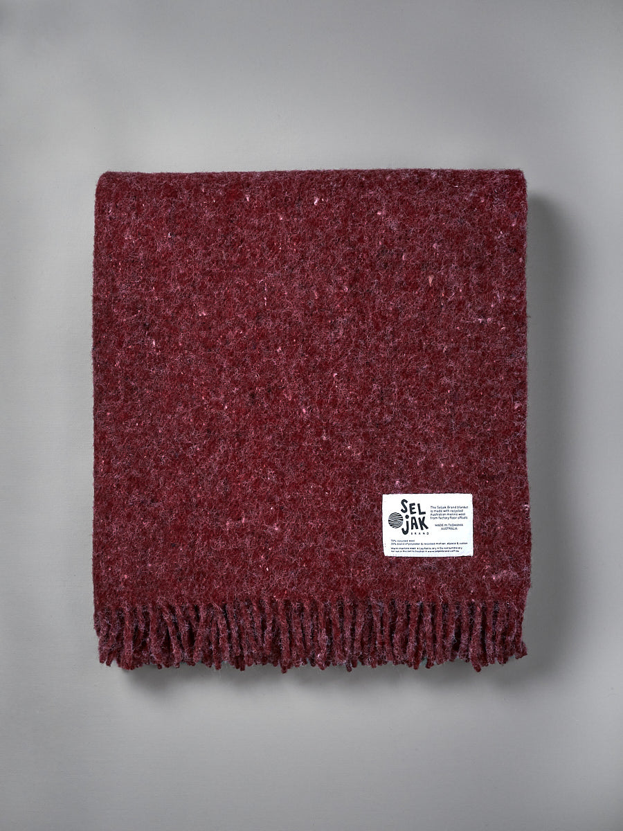 A Pinot Blanket – Fringe with a Seljak Brand label on it.