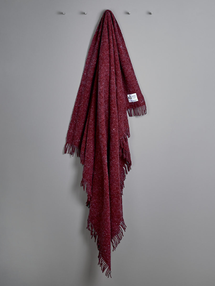 A Pinot Blanket – Fringe by Seljak Brand hanging on a wall.
