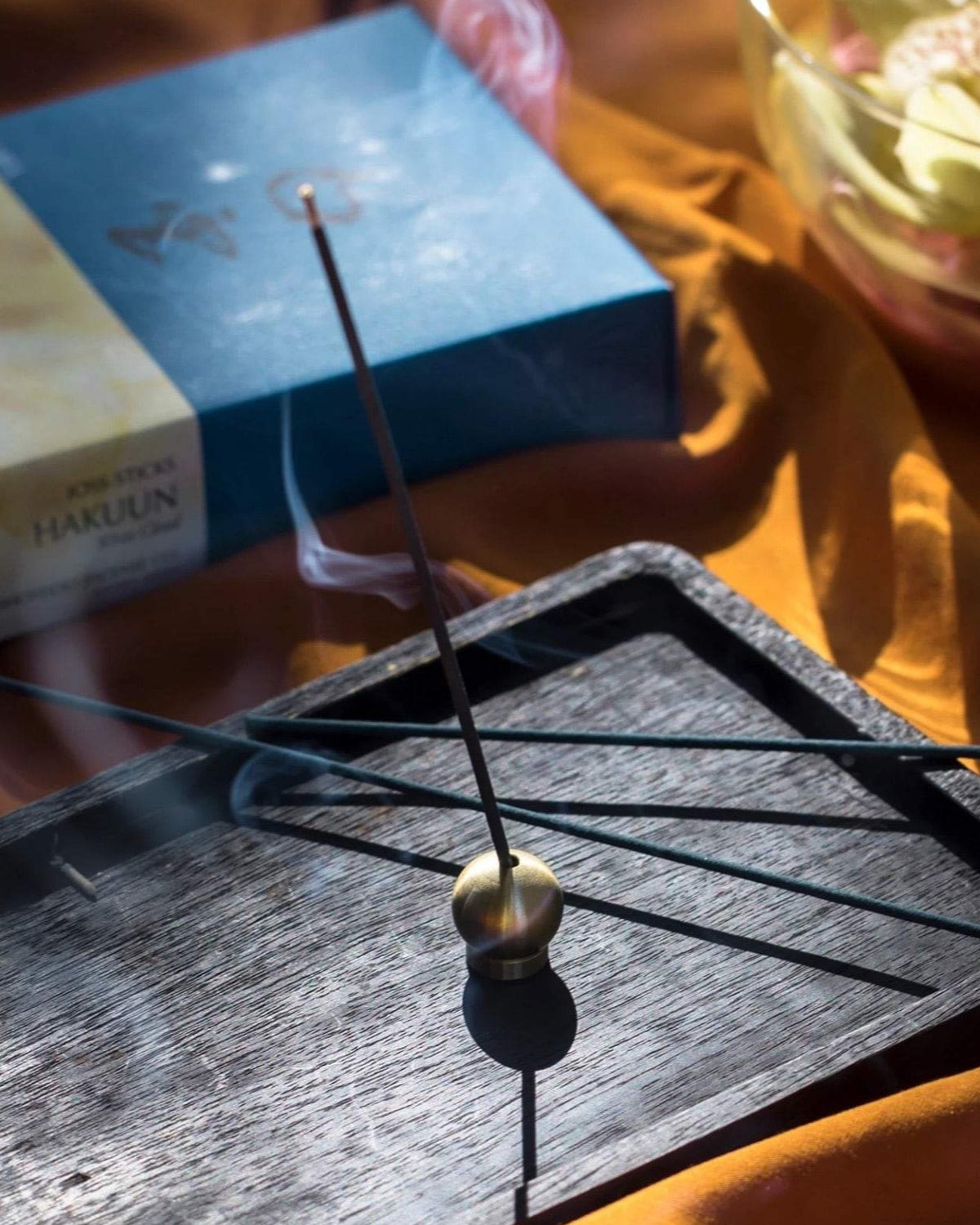 Brass Ball Incense Holders on a tray next to a box of Senko incense.