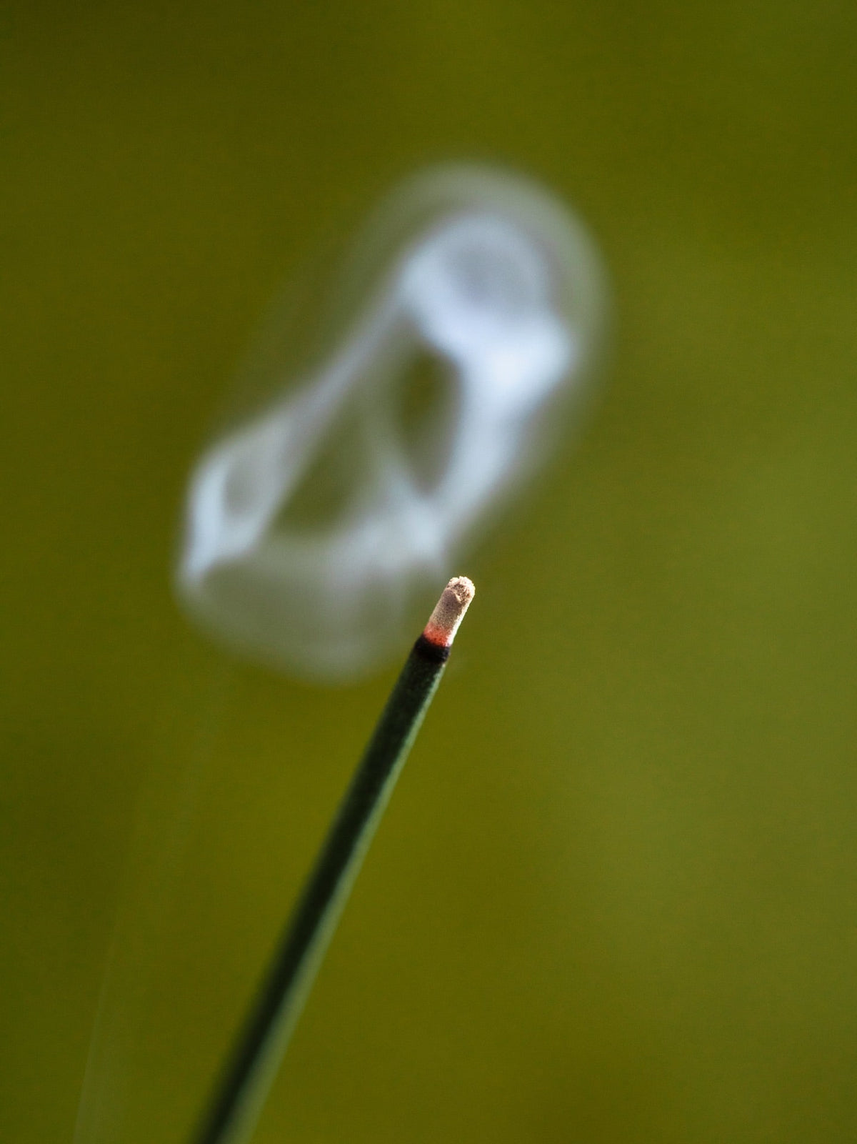 A Senko Cherry Blossom – Kyozakura incense stick with smoke coming out of it.