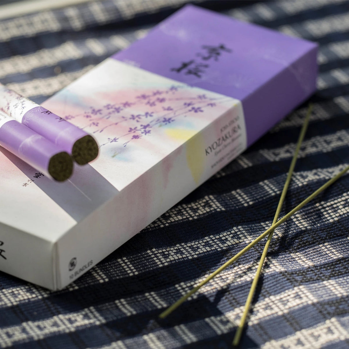 Senko Cherry Blossom – Kyozakura incense sticks on a table next to a box.
