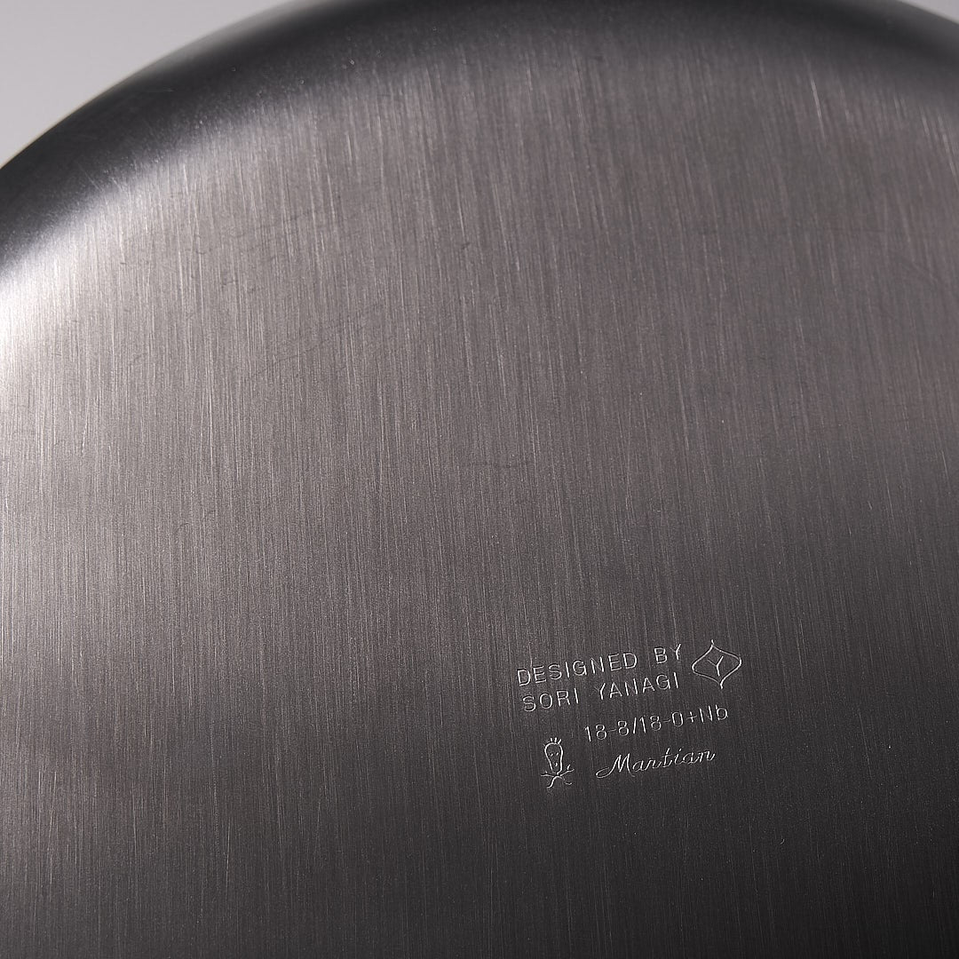 A close up of a Sori Yanagi stove-top kettle - brushed steel.
