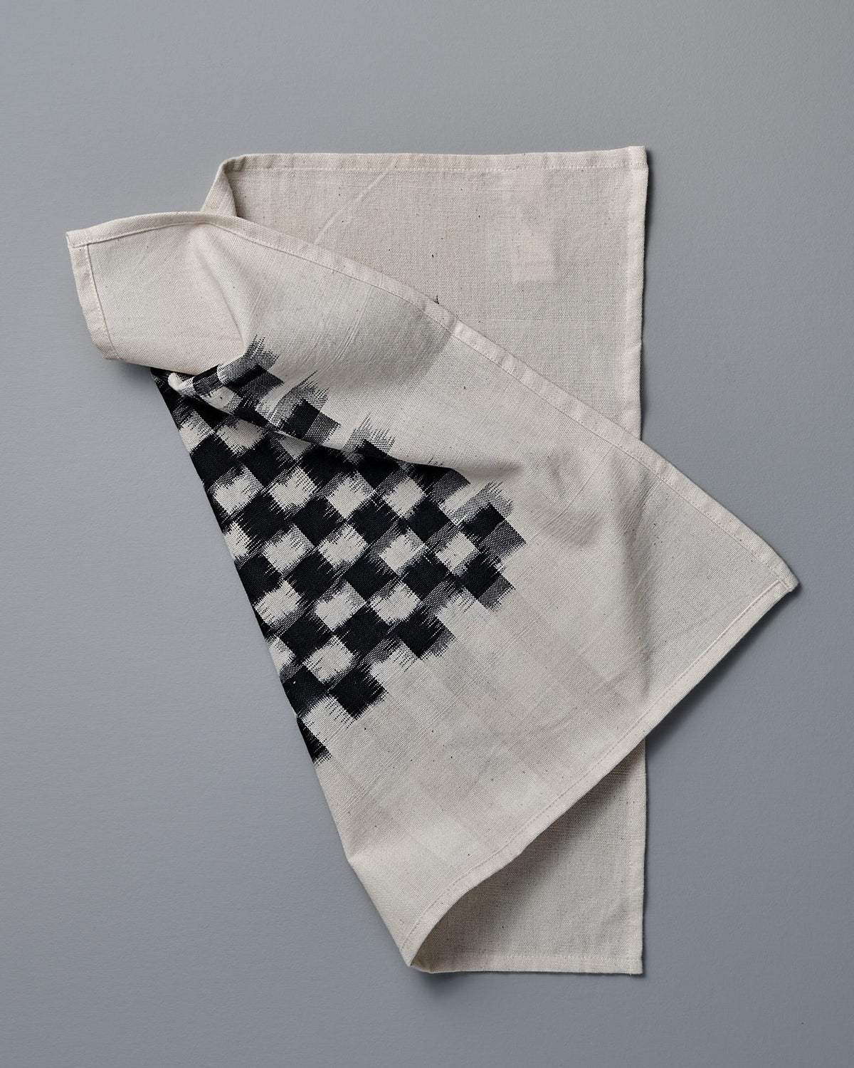 A Stitchwallah towel with a black and white checkered pattern.