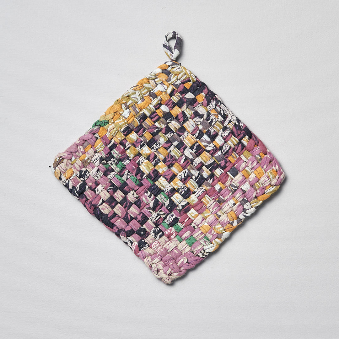 A square Stitchwallah Sari Pot &amp; Oven-tray Holder hanging on a white surface.