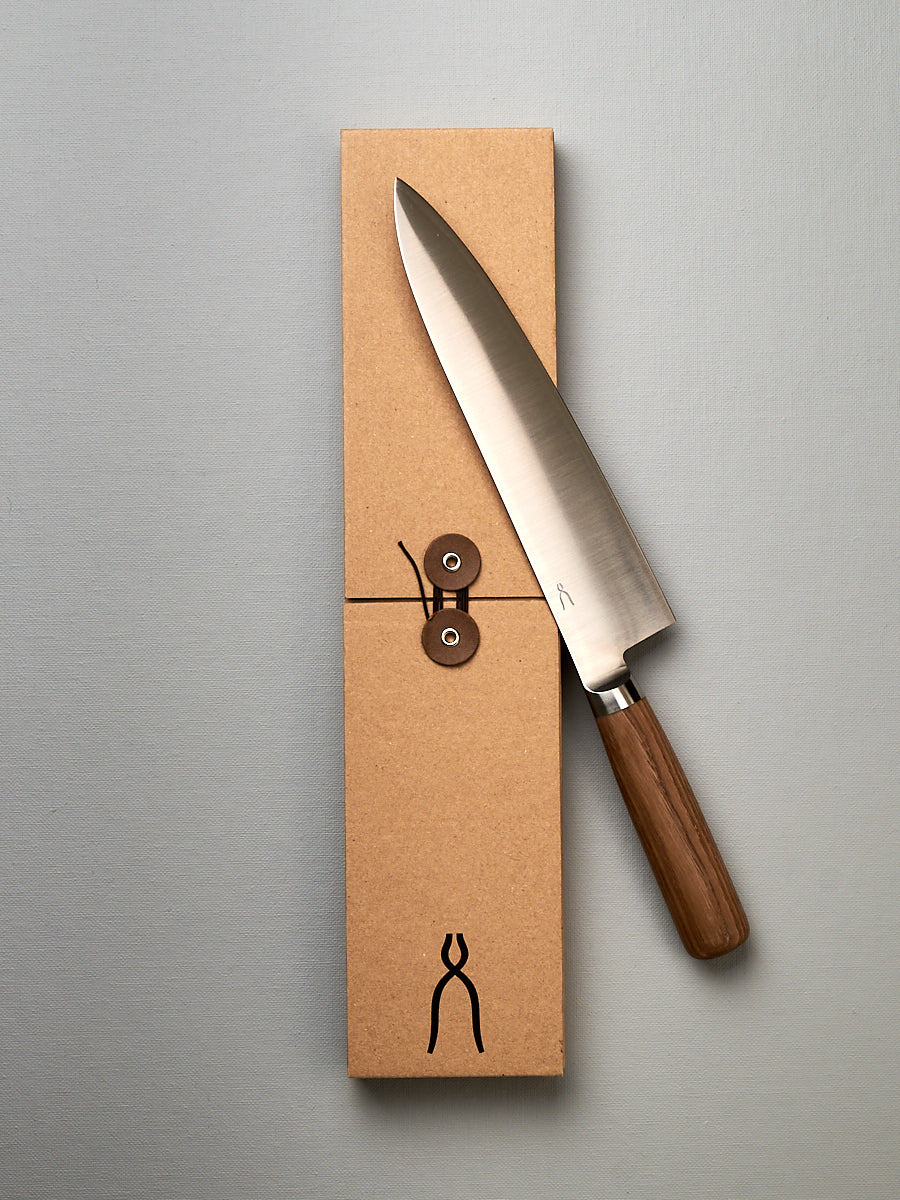 A brown box with a Tadafusa Hocho Gyuto Knife in it.