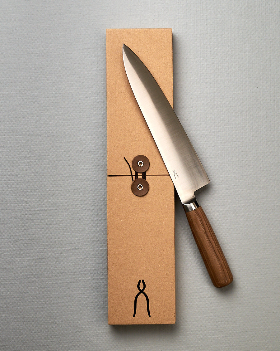 A brown box with a Tadafusa Hocho Gyuto Knife in it.