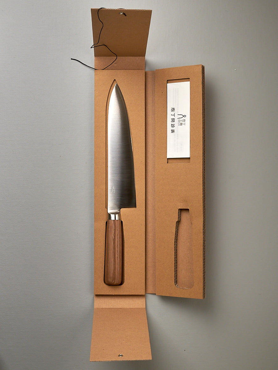 A Tadafusa Hocho Gyuto Knife in a cardboard box with a label on it.