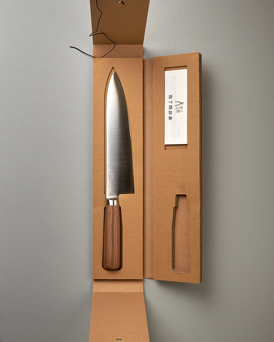 A Tadafusa Hocho Gyuto Knife in a cardboard box with a label on it.